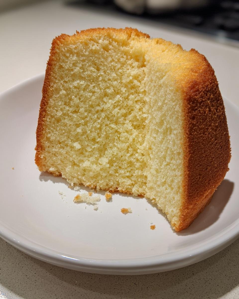 Close-up of a light, airy slice of Lemon Chiffon Cake Recipe showing its fine crumb structure.