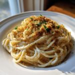 A serving of creamy Garlic Bread Pasta topped generously with golden toasted breadcrumbs and fresh parsley.