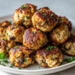 A close-up stack of perfectly browned Mushroom Chicken Meatballs garnished with fresh parsley.