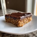 A single, thick square of No Bake Chocolate Peanut Butter Oat Bars with a rich chocolate topping.